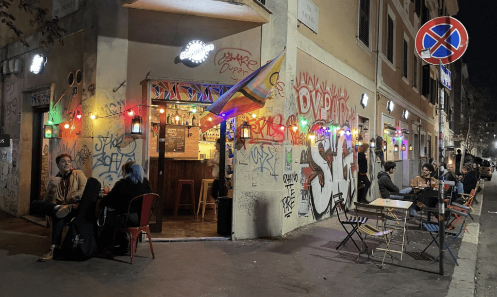 A graffiti wall next to a restaurant.