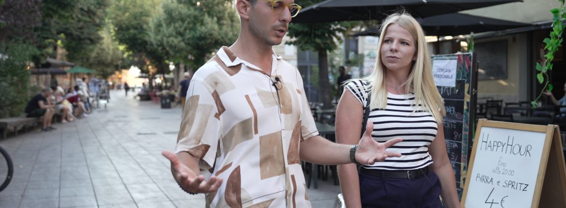 A woman walks with an Italian tour guide.