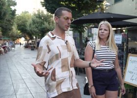 A woman walks with an Italian tour guide.