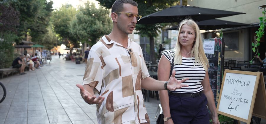 A woman walks with an Italian tour guide.