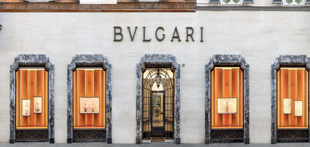 White building with a large sign in black letters reading "Bulgari"