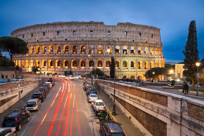 Rome, Italy at the Colosseum over the street at night.