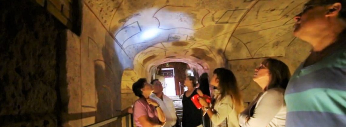 people standing in Rome Catacombs