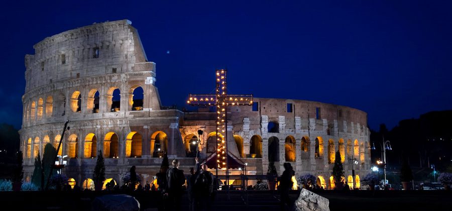 Evening view of the cross in front of the colosseum during the Via Crucis at easter in Rome