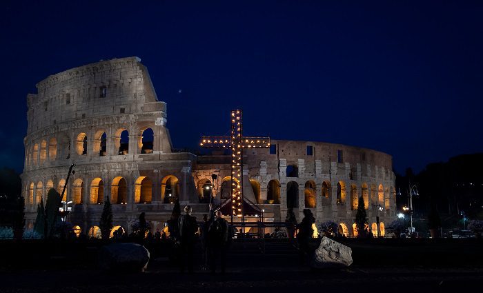 Evening view of the cross in front of the colosseum during the Via Crucis at easter in Rome