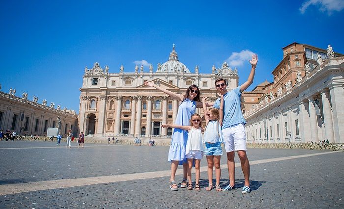 A Family standing in front of St. Peter's Basilica in Vatican City
