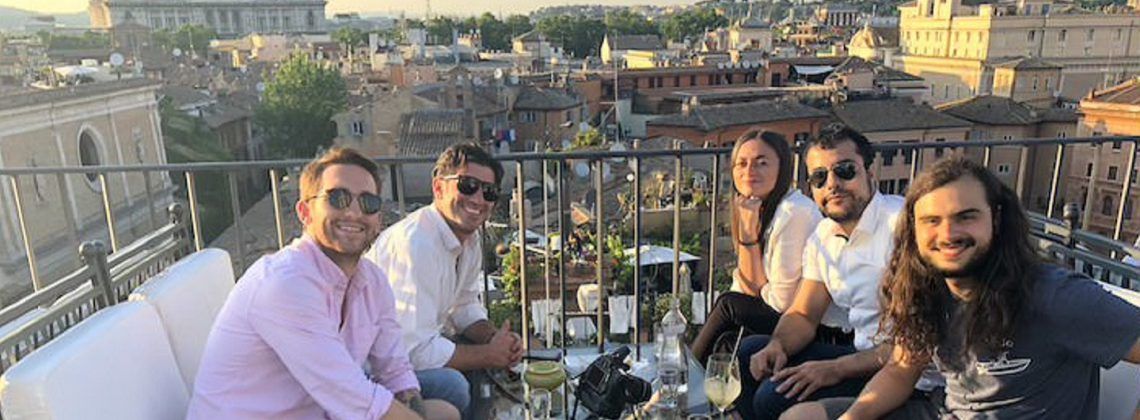smiling and happy people on the rooftop of a restaurant