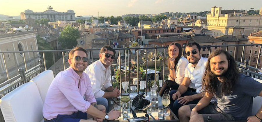 smiling and happy people on the rooftop of a restaurant