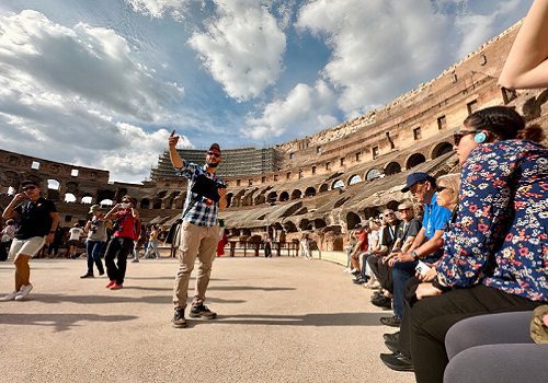 main standing on arena with people watching