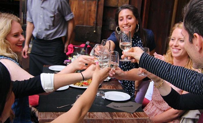 people eating and toasting on food tour