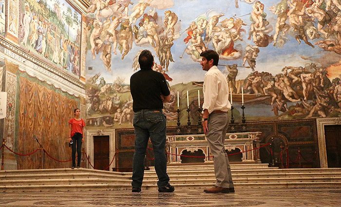 guide and man alone in sistine chapel