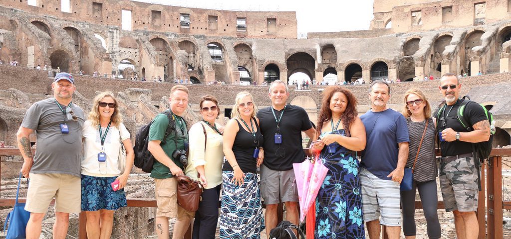 happy people posing on colosseum arena floor