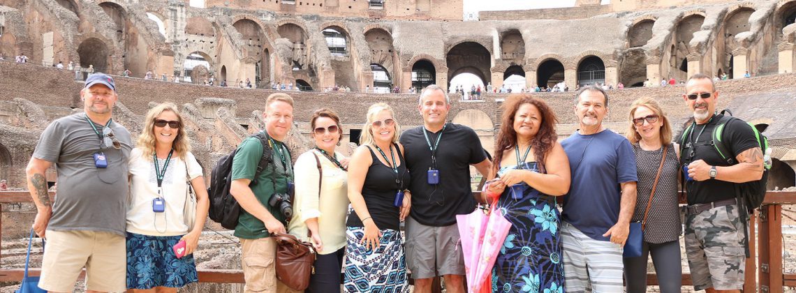 happy people posing on colosseum arena floor