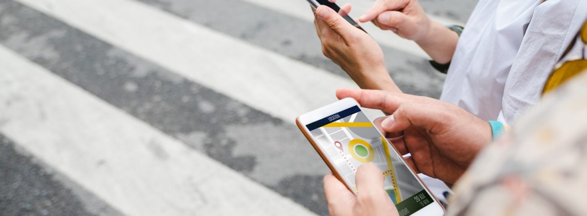 people with smartphone looking for directions in an app