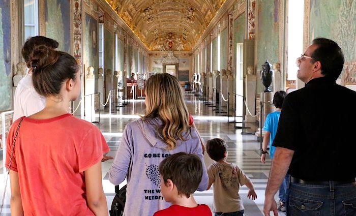 Family walking through the Gallery of Maps at the Vatican Museums.