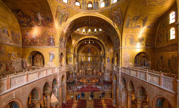 Golden interior of St. Mark's Basilica with elaborate decorations and mosaics