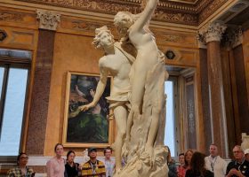 people looking at apollo and daphne sculpture at borghese