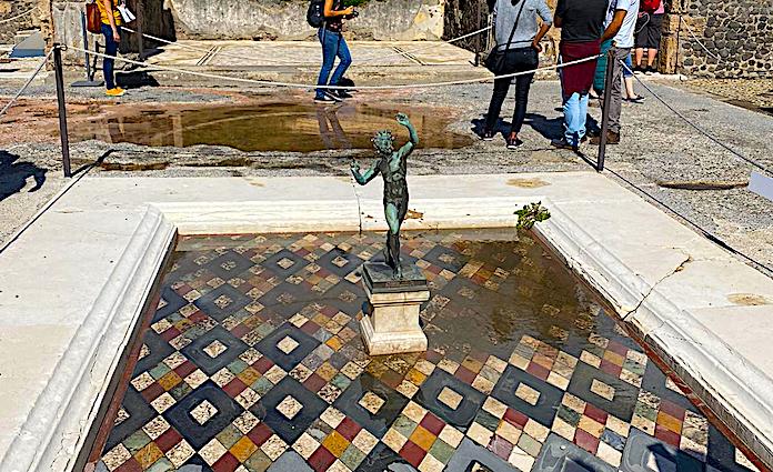 Statue of a fuan in a water feature at the house of the faun in the Pompeii Archaeological  Park.
