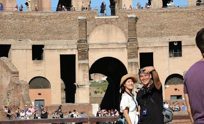 A couple taking a selfie on the special-access Arena Floor in the Colosseum of Rome