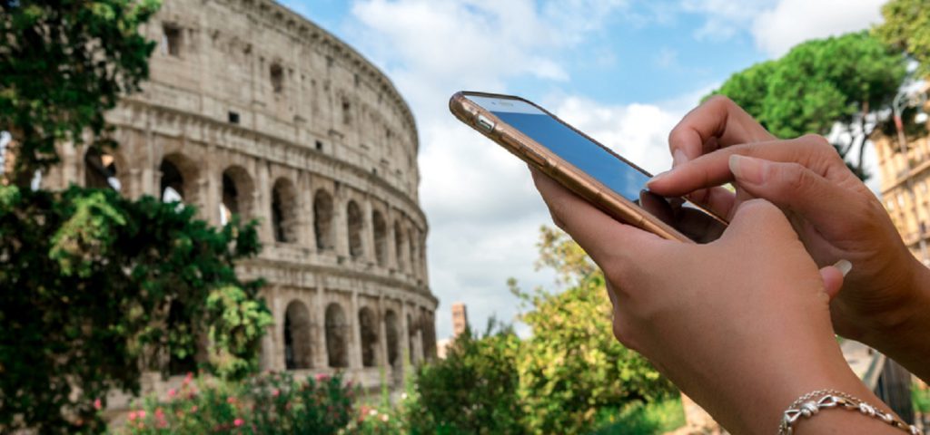 woman using iphone in front of the colosseum