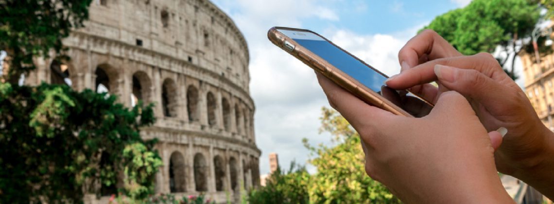 woman using iphone in front of the colosseum