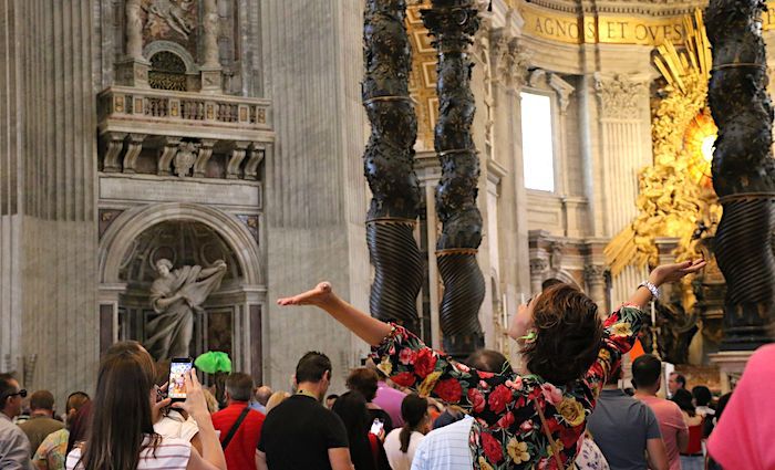 Visitors admiring the inside of St. Peter's Basilica